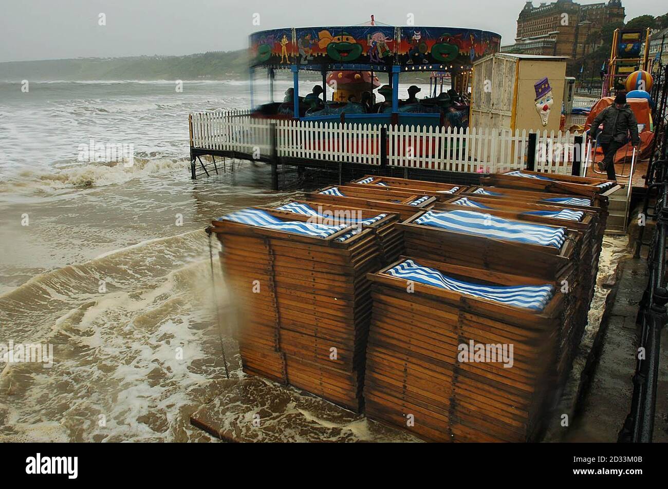 The piles of deckchairs and seafront amusement arcades are short of customers, as gale force winds, high tides and torrential rain pound the beach at Scarborough. As the UK recovers from some of the worst summer storms on record, thousands of homes were still without electricity. Stock Photo