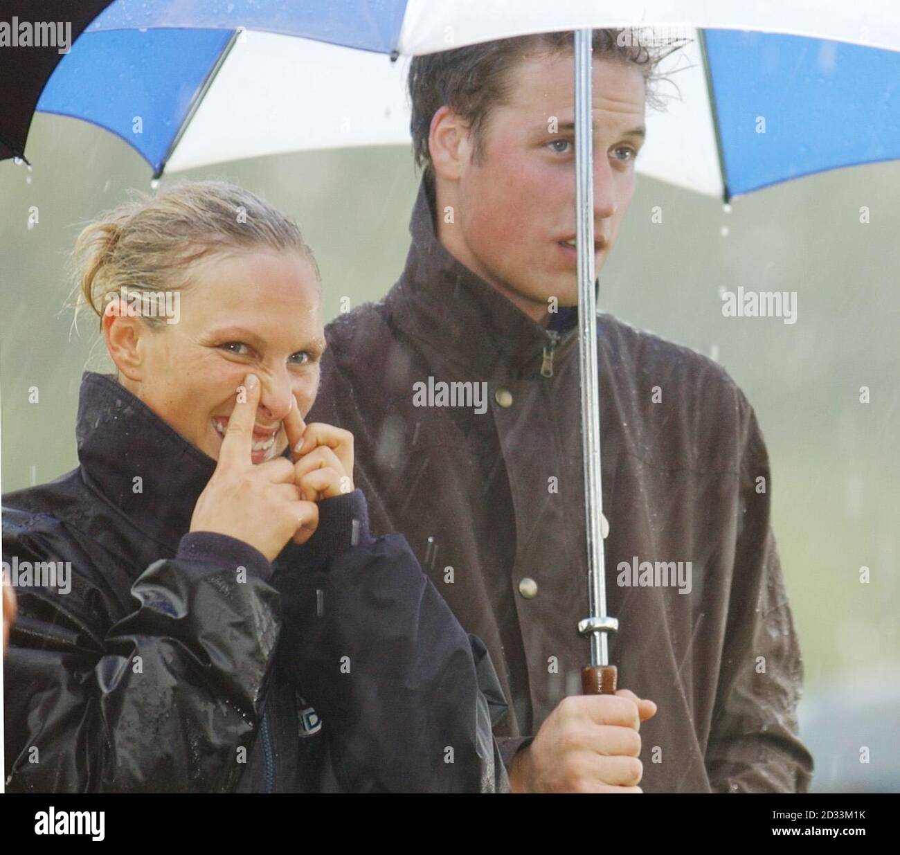 Zara Phillips tries to deal with the pouring rain as her cousin Prince  William holds the umbrella during the presentation ceremony of the Indian  Cavalry Officers Polo Trophy at Tidworth Polo Club.