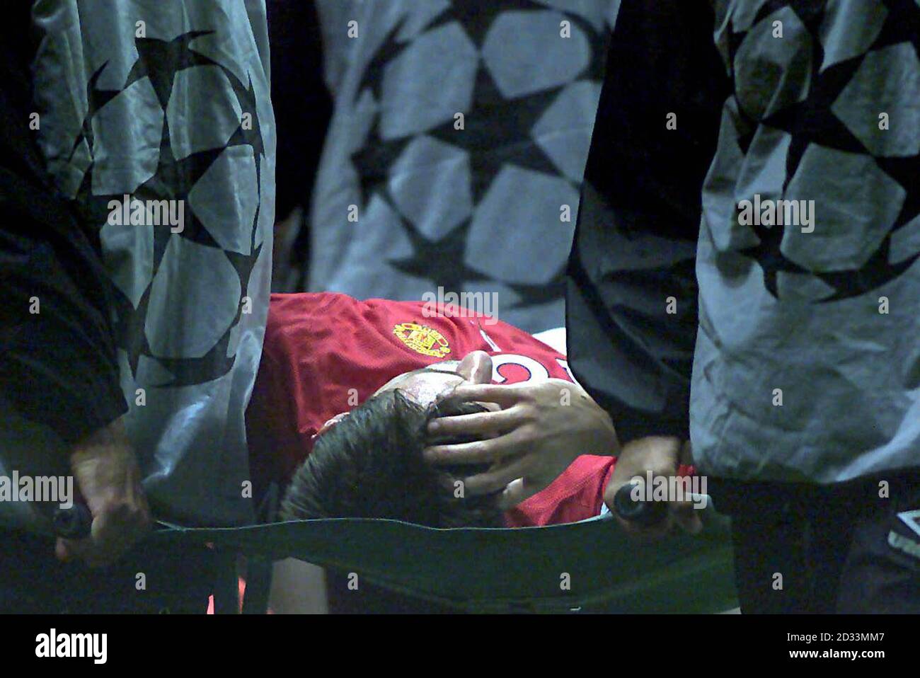 Manchester United's Gary Neville is carried off after a clash of heads