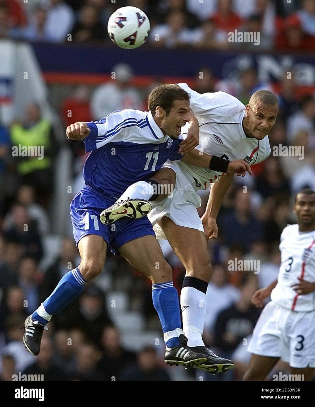 England's Rio Ferdinand battles for the ball against Themis Nikolaidis (left) of Greece during the FIFA World Cup European Qualifying Group Nine match at Old Trafford, Manchester.   eg Stock Photo