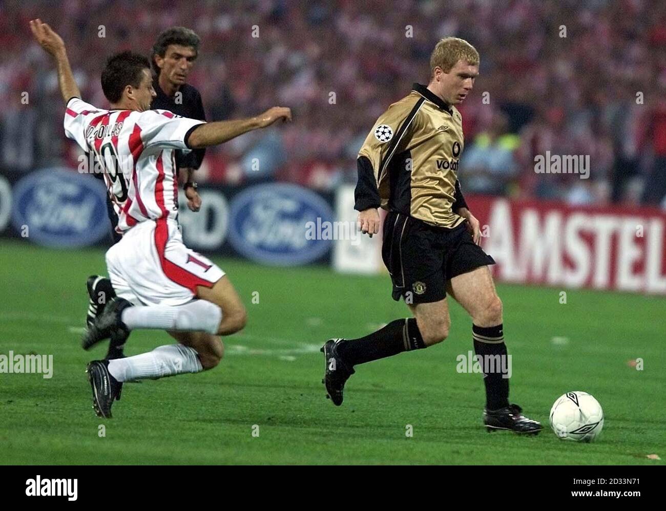 Manchester United's Paul Scholes battles for the ball Olympiakos's  Athanasions Kostoulas during the UEFA Champions League Group G match at The  Spyros Louis, Pireas, Greece. THIS PICTURE CAN ONLY BE USED WITHIN