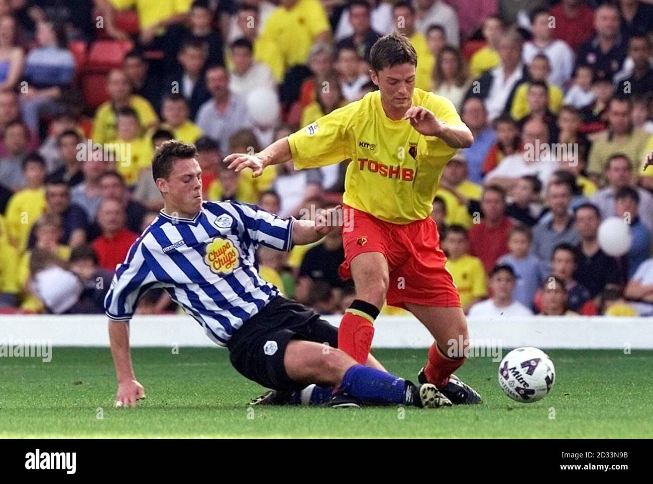 Watford's Stephen Hughes (right) is tackled by Sheffield Wednesday's Tony Crane during the Nationwide Division One match at Vicarage Road, Watford. THIS PICTURE CAN ONLY BE USED WITHIN THE CONTEXT OF AN EDITORIAL FEATURE. NO UNOFFICIAL CLUB WEBSITE USE. Stock Photo