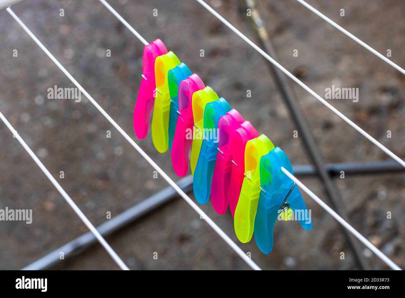 Colorful plastic clothes pegs on empty metal clothes dryer Stock Photo Alamy