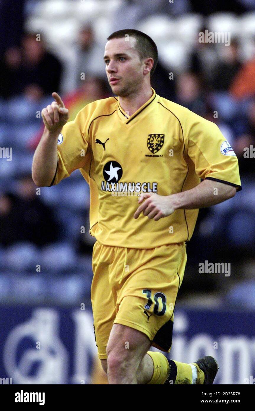 Wimbledon's David Connolly celebrates after a first-half free kick puts his team 2-0 up against Stockport County in their Nationwide League Division One match at Edgeley Park, Stockport. A late first-half goal from Stockport later put the half-time score at 2-1.   THIS PICTURE CAN ONLY BE USED WITHIN THE CONTEXT OF AN EDITORIAL FEATURE. NO UNOFFICIAL CLUB WEBSITE USE. Stock Photo