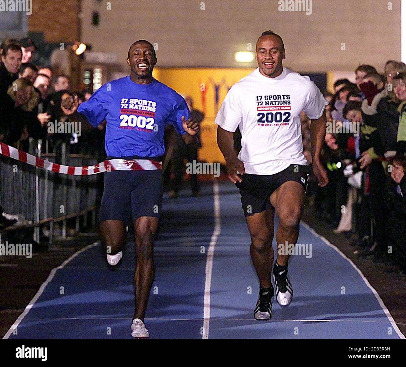 Linford Christie pips Jonah Lomu at the line in the 50 meter sprint at The Printworks, Manchester. New Zealand All Blacks' Jonah Lomu took on former Olympic gold medalist Linford Christie in a head-to-head sprint.  *   as part of the countdown towards the 2002 Commonwealth Games. Stock Photo