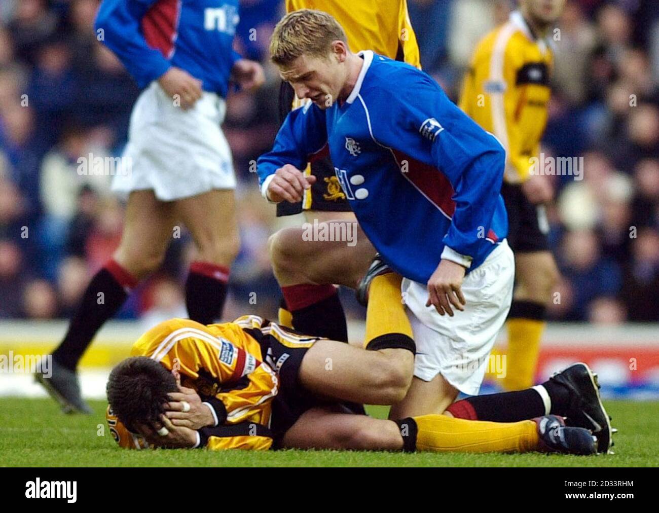Rangers' Tore Andre Flo looks down at Livingston's Oscar Rubio who clutches his hands to his injured nose, before leaving the field at today's Scottish Premier League match at Glasgow's Ibrox stadium. Stock Photo