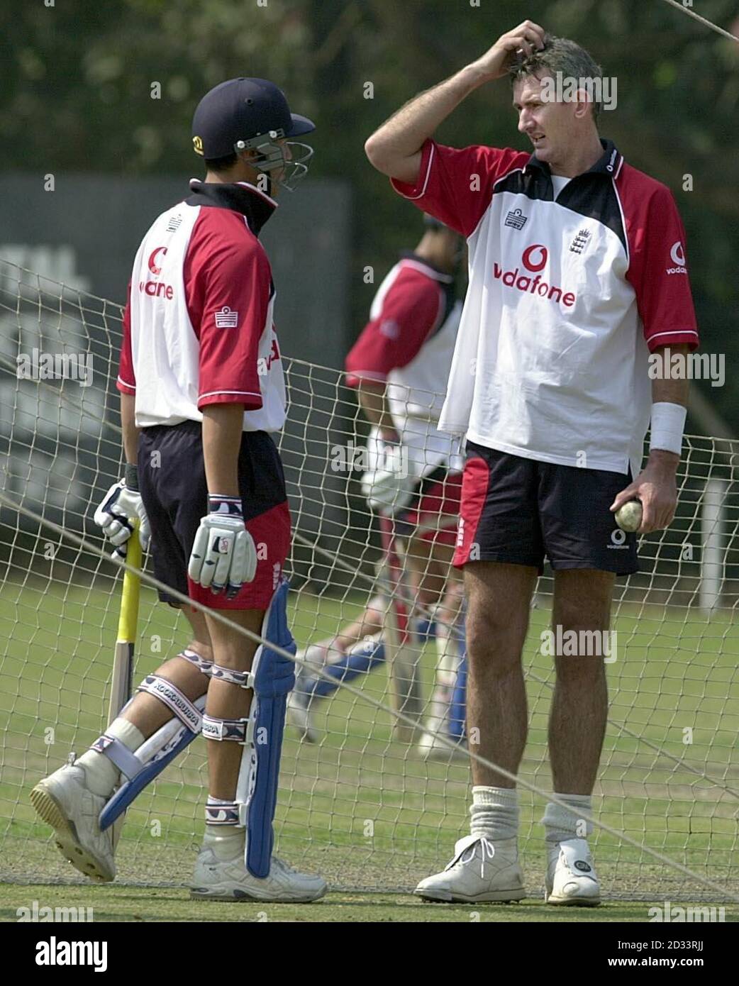 England bowler Andrew Caddick (right) talks to Ben Hollioake during net