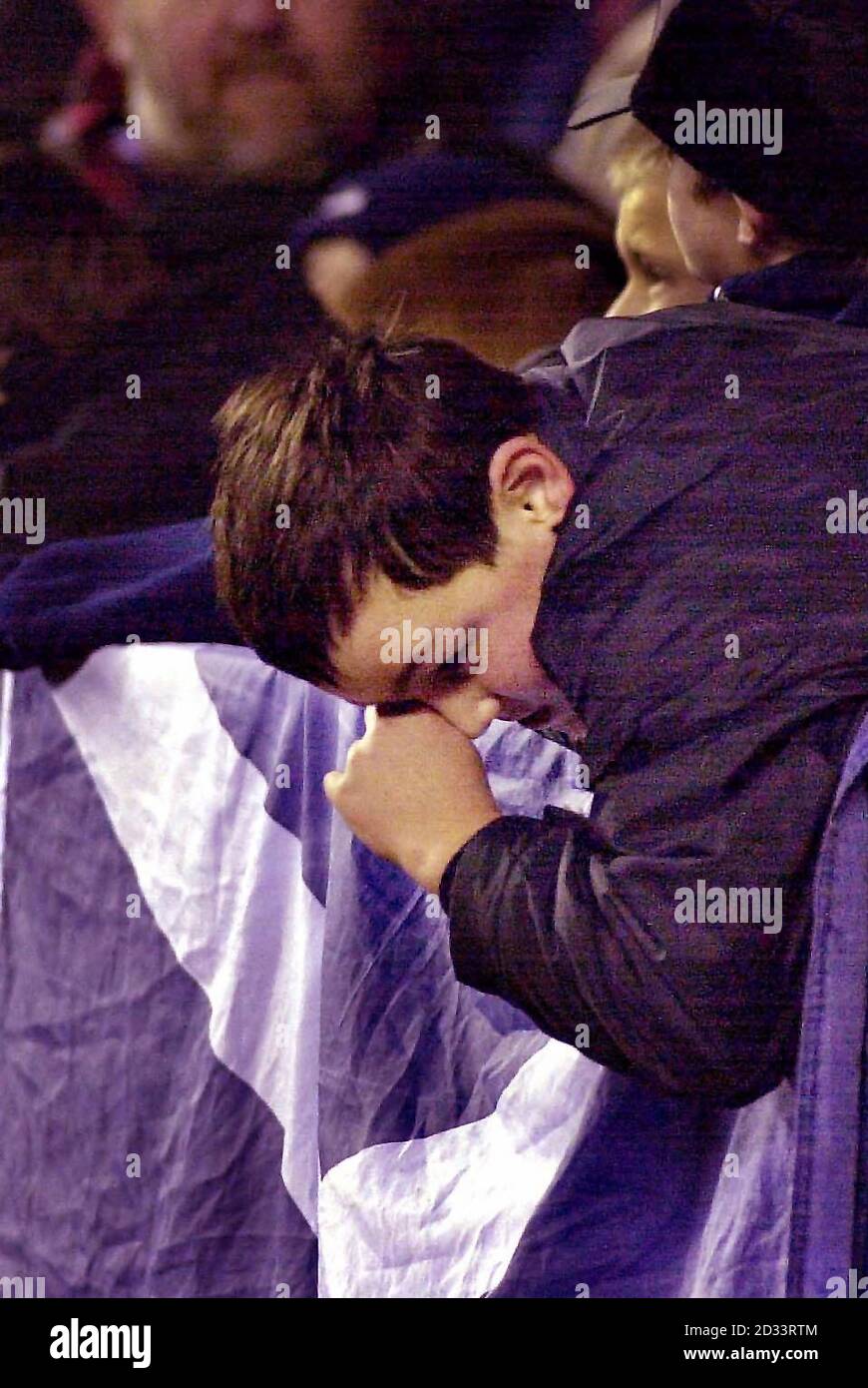 A Scotland fan slumps over his flag, after losing to England following the Lloyds TSB Six Nations Championship match at Murrayfield in Edinburgh, Scotland. Scotland (3) v England (29). Stock Photo