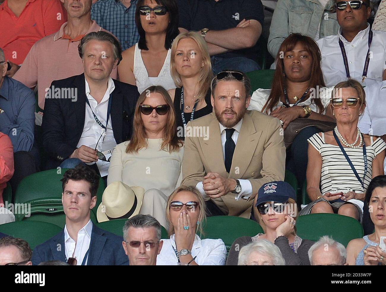 Stella McCartney with her husband Alasdhair Willis on Centre Court during  day twelve of the Wimbledon Championships at the All England Lawn Tennis  and Croquet Club, Wimbledon Stock Photo - Alamy