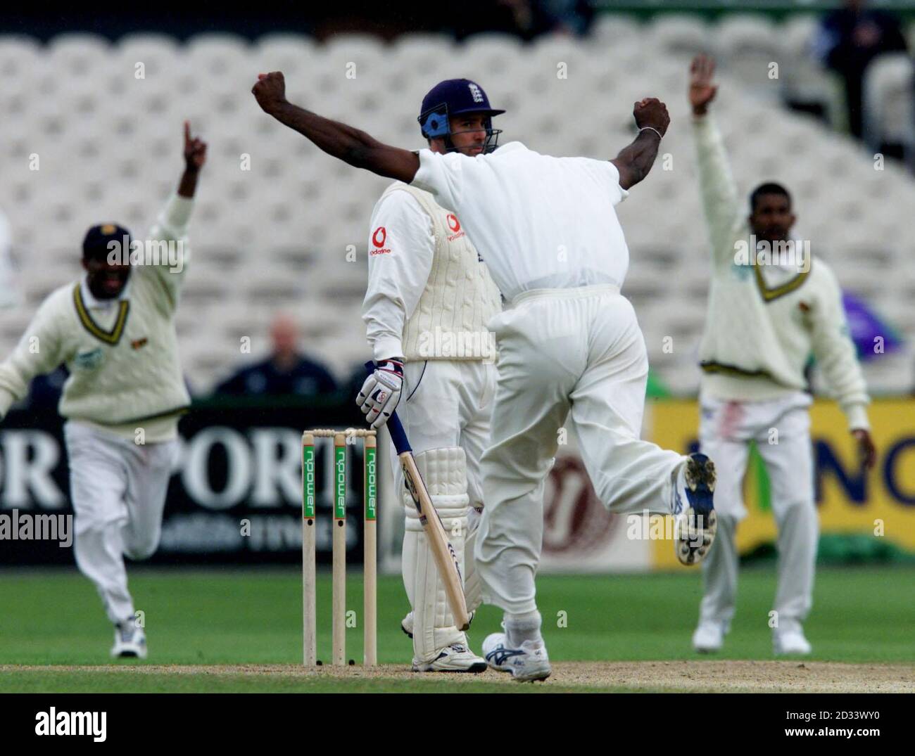 England's Graham Thorpe looks hard at the umpire as a head down Sri Lankan bowler Eric Upashantha celebrates gaining Thorpe's wicket, caught by Sangakkara, during 3rd nPower Test at Old Trafford, Manchester. Stock Photo