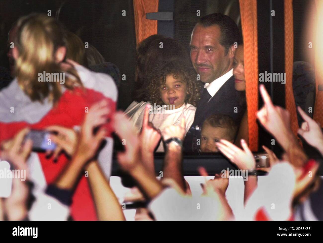 England goalkeeper David Seaman holding his daughter Georgina on a coach at Heathrow Airport, London. The England team have arrived back from Japan after being knocked out by Brazil in the quarter-finals of the 2002 World Cup.  THIS PICTURE CAN ONLY BE USED WITHIN THE CONTEXT OF AN EDITORIAL FEATURE. NO WEBSITE/INTERNET USE UNLESS SITE IS REGISTERED WITH FOOTBALL ASSOCIATION PREMIER LEAGUE. Stock Photo