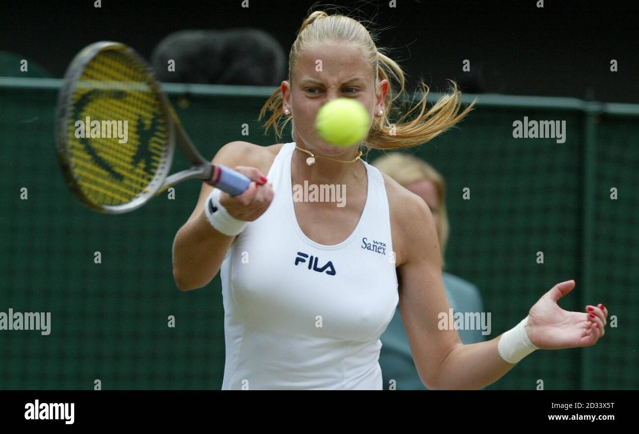 EDITORIAL USE ONLY, NO COMMERCIAL USE. Yugoslavian Jelena Dokic, the 7th seed in action against Nathalie Dechy of France on Centre Court at Wimbledon during The tennis championships. Stock Photo