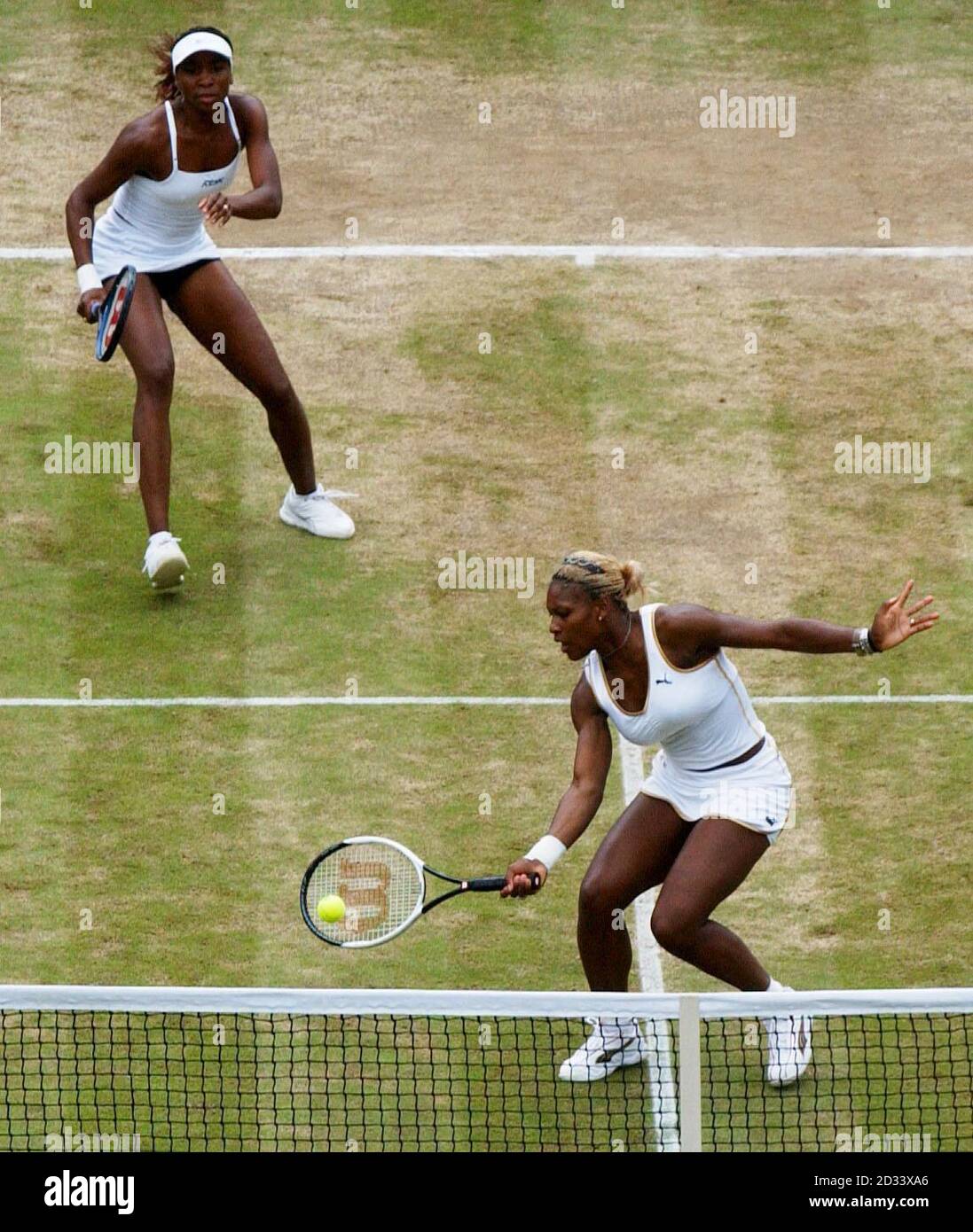 Sisters Venus and Serena Williams from America in action against Tina Krizan and Katarina Srebotnik of Slovakia in the ladies' doubles quarter final on Court One at Wimbledon. Stock Photo