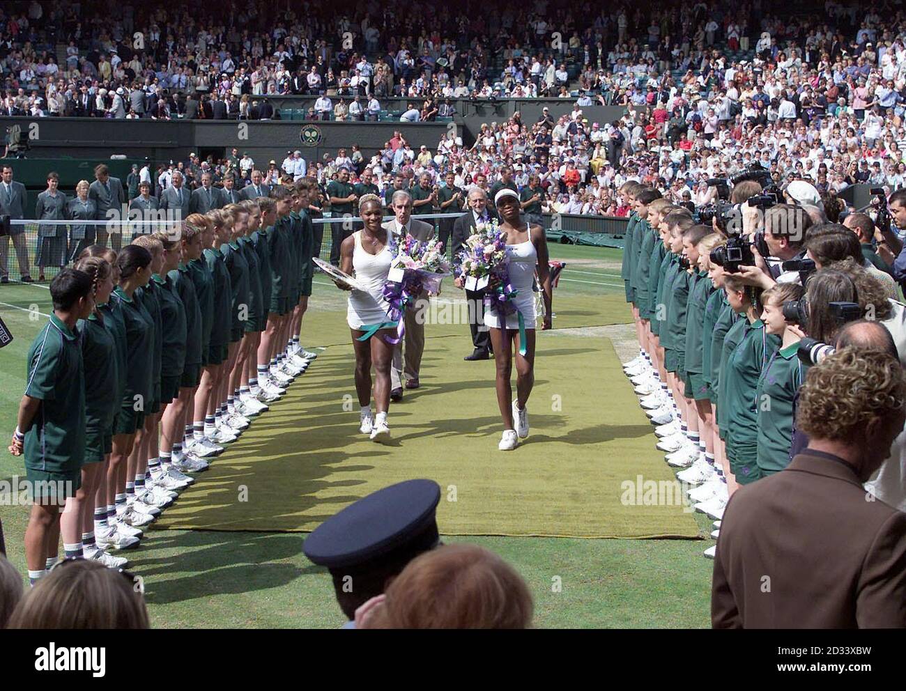 EDITORIAL USE ONLY, NO COMMERCIAL USE. Serena Williams (left) and her sister Venus from the USA leave Centre Court after making history as the first sisters to meet in the Ladies' Singles Final at Wimbledon in 118 years. Serena won in straight sets 7:6/6:3.  Stock Photo