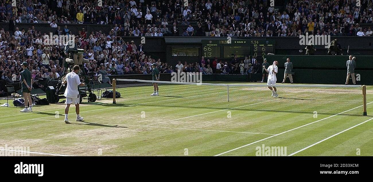 EDITORIAL USE ONLY, NO COMMERCIAL USE. The world's top seed Lleyton Hewitt of Australia (far end) celebrates beating David Nalbandian from Argentina in the Mens' Singles Final at Wimbledon.  *   The tennis championships at The All England Lawn Tennis Club is the first time Nalbandian has played competition grass court tennis. Hewitt won in straight sets 6:1/6:3/6:2.  Stock Photo