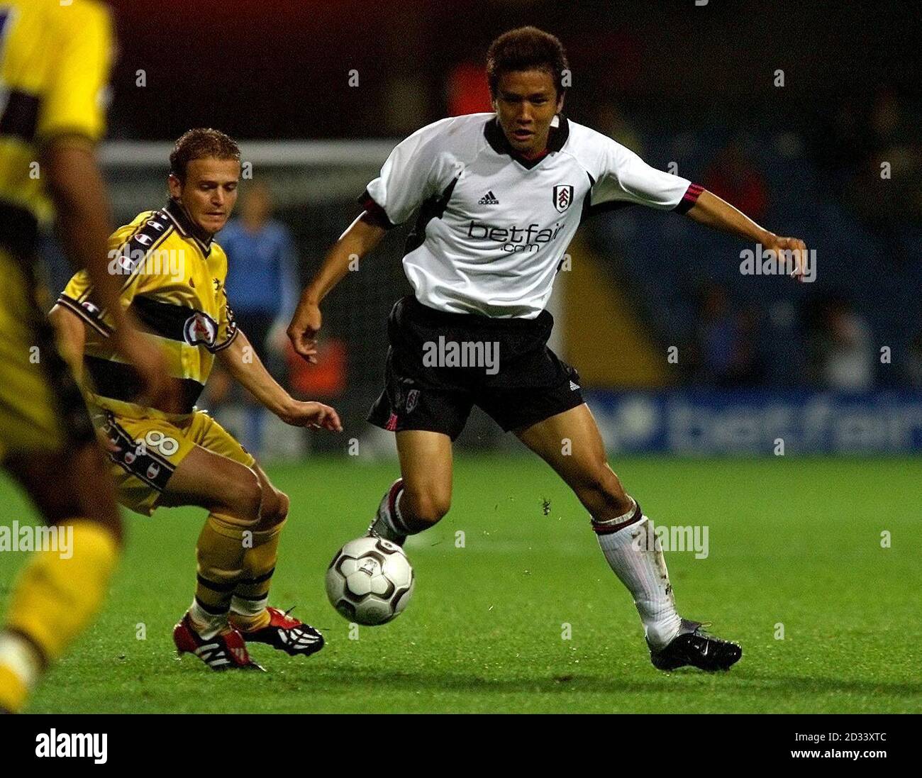 Junichi Inamoto of Fulham gets past Fabien Boudarne of Sochaux during Fulham's 1-0 victory in tonights Intertoto Cup Semi Final 1st Leg at Loftus Road, London. Stock Photo