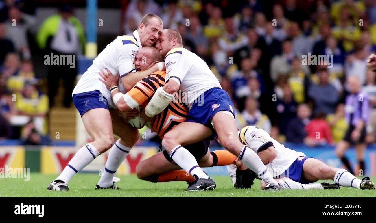 Castleford's Nathan Sykes is caught by Warrington's Nick Fozzard (left), Mark Hilton (centre) and Jon Clarke (right) during their Tetley Bitter Super League game at Wilderspool, Warrington. Stock Photo