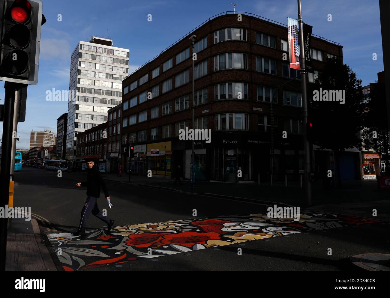 Leicester, Leicestershire, UK. 7th October 2020. A man walks on pedestrian crossing redesigned with colourful coverings 100 days since the UKÕs first local coronavirus pandemic lockdown was announced in the city. Credit Darren Staples/Alamy Live News. Stock Photo