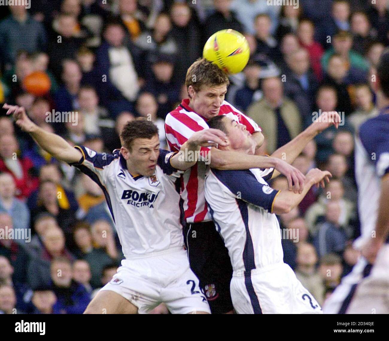 Lincoln City's Ben Futcher (centre) wins an aerial battle against Hull City's Steve Burton (left) and Damien Delaney, during their Nationwide Division Three match at Lincoln's Sincil Bank ground. THIS PICTURE CAN ONLY BE USED WITHIN THE CONTEXT OF AN EDITORIAL FEATURE. NO UNOFFICIAL CLUB WEBSITE USE. Stock Photo