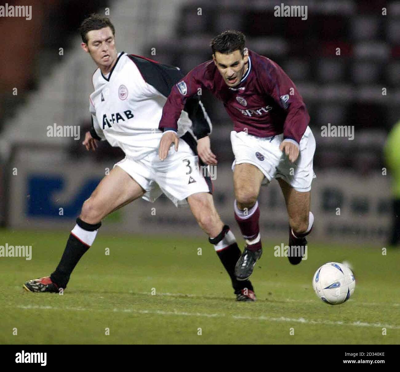 Aberdeen's Jamie McAllister and Hearts' Jean Louis Valois battle for the ball during their Bank of Scotland Scottish Premier League match at Hearts' Tynecastle Park ground in Edinburgh. Stock Photo