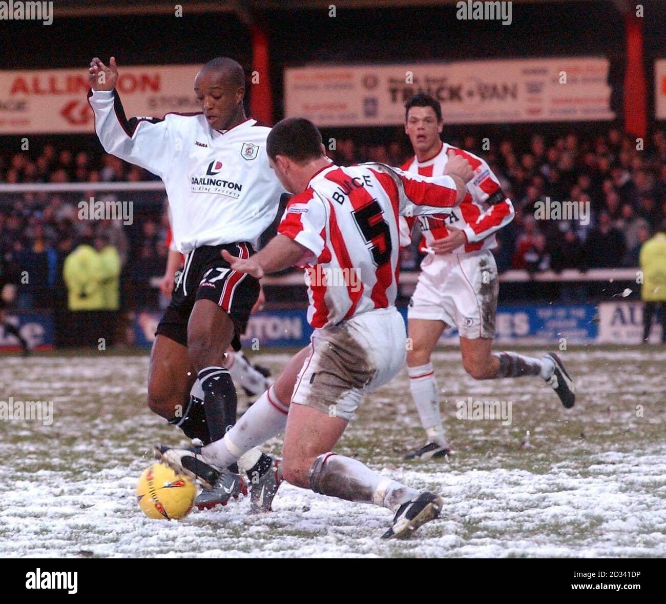 Darlington's Richard Offiong (left) in action against Farnborough's Gareth Griffiths during their FA Cup Third Round match at Darlington's Feethams Ground. Stock Photo