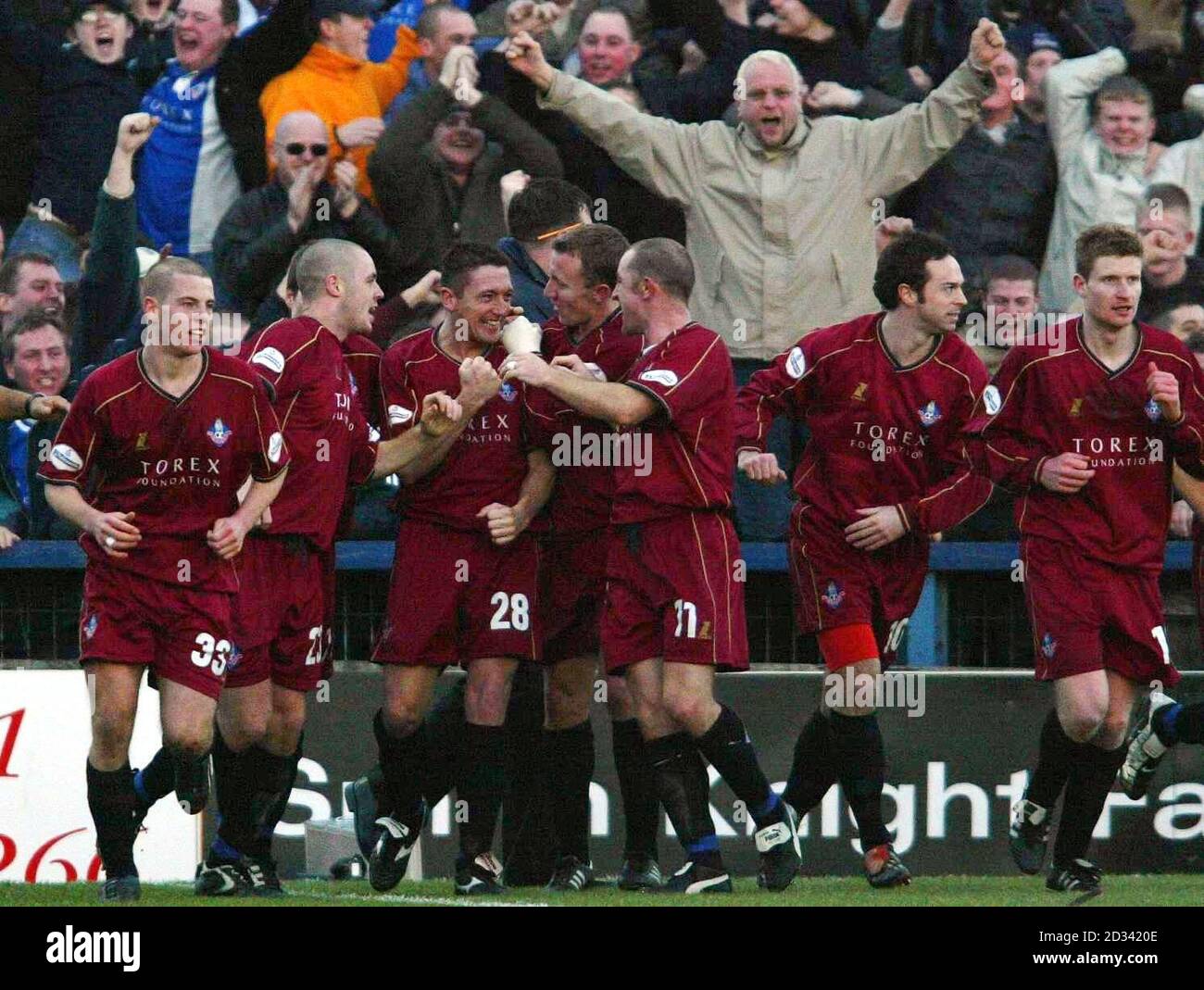 Oldham players and fans celebrate after David Eyres (third from left) scored the winning goal against Stockport, during their Nationwide Division Two match at Edgeley Park, Stockport.  Final score: Stockport 1, Oldham 2.   THIS PICTURE CAN ONLY BE USED WITHIN THE CONTEXT OF AN EDITORIAL FEATURE. NO UNOFFICIAL CLUB WEBSITE USE. Stock Photo