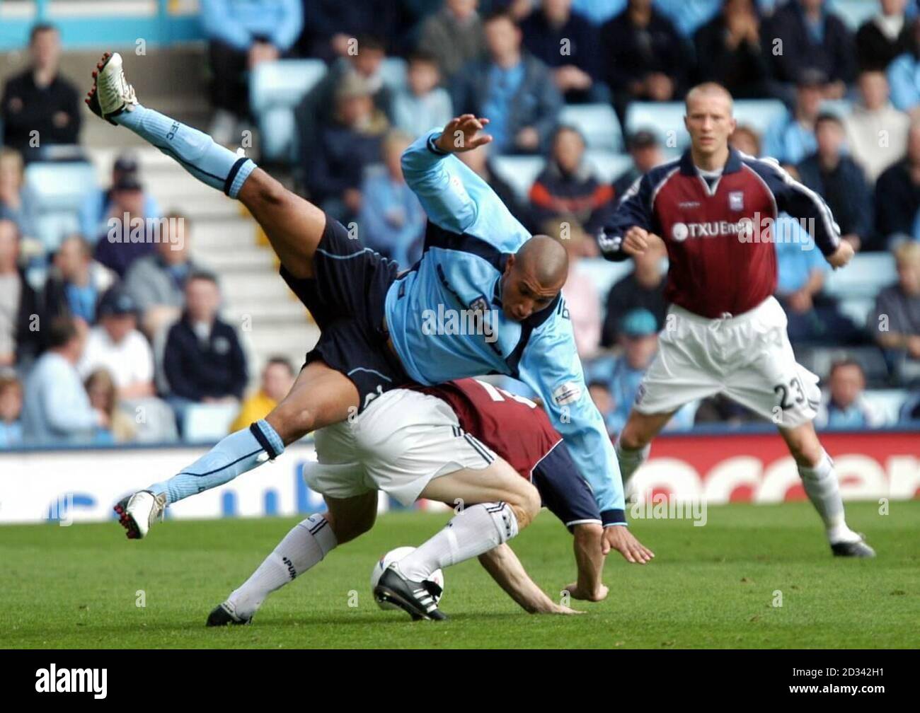 Coventry City's Jay Bothroyd (front) is tackled by an Ipswich defender during their Nationwide Division One match at Coventry's Highfield Road Stadium.  THIS PICTURE CAN ONLY BE USED WITHIN THE CONTEXT OF AN EDITORIAL FEATURE. NO UNOFFICIAL CLUB WEBSITE USE. Stock Photo