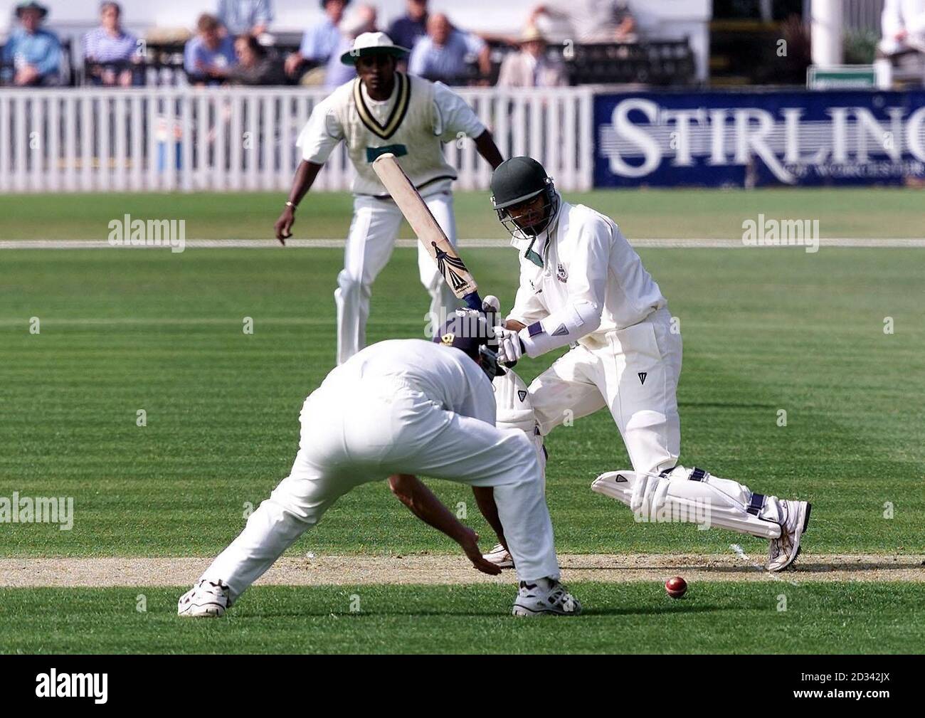 Worcestershire opener Anurag Singh clips the ball past Hampshire's Robin Smith on the opening day of the season against Hampshire at New Road, Worcester. Stock Photo