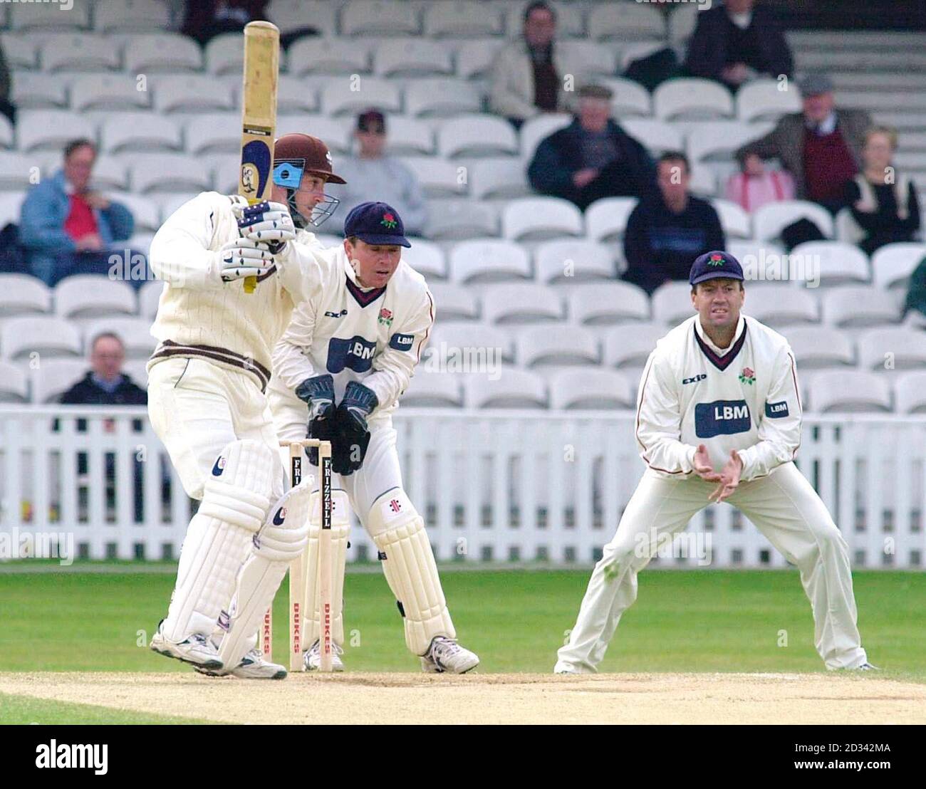 Surrey's Graham Thorpe hits the ball for 4 runs, watched by Lancashire wicketkeeper Warren Hegg and slip fielder Stuart Law, during the Frizzell County Championship match against Lancashire at the Oval, London. Stock Photo