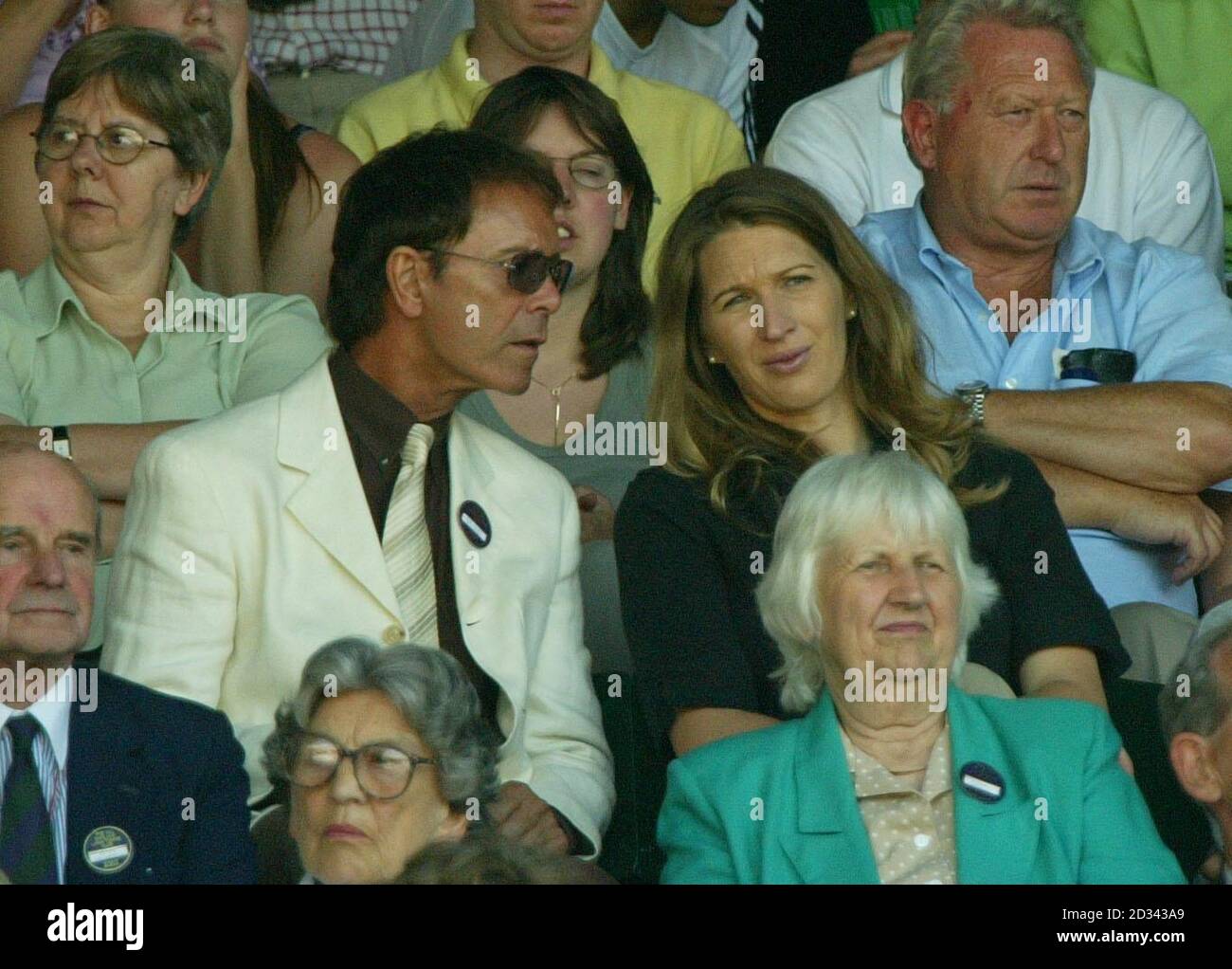 EDITORIAL USE ONLY, NO MOBILE PHONE USE. Sir Cliff Richard and former Wimbledon champion Steffi Graff watch Steffi's husband Andre Agassi in action on Centre Court against Britain's Jamie Delgado at the All England Lawn Tennis Championships in Wimbledon. Stock Photo