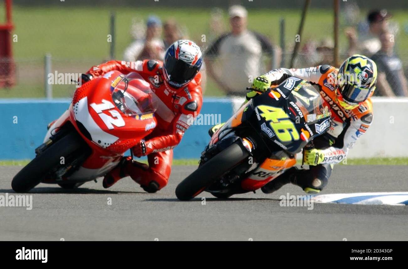 Italy's and Repsol Honda rider Valentino Rossi (46) and Australia's and Ducati Marlboro Team Troy Bayliss (12) during MotoGP free practice at the Cinzano British Grand Prix, Donington Park, Leicestershire. Stock Photo