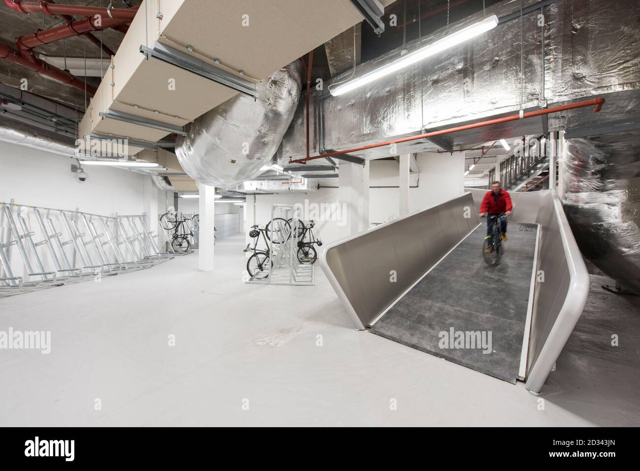 Underground cycle ramp leading to cycle parking facilities. Verde SW1, London, United Kingdom. Architect: Aukett Swanke & Adjaye Associates, 2016. Stock Photo
