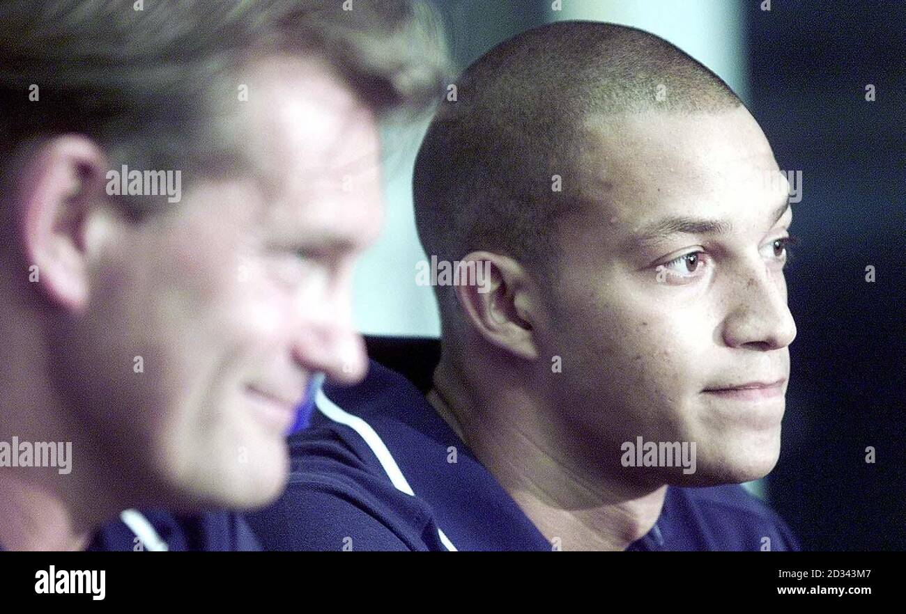 Tottenham Hotspur new signing Bobby Zamora (right) is unveiled by manager Glenn Hoddle during a press conference at Whitehart Lane, London. Hoddle was delighted to have signed Zamora after admitting he had tracked the striker for two years. Zamora was a goalscoring sensation at Brighton, hitting more than 30 goals a season as the Seagulls won back-to-back promotions in 2001 and 2002, and became one of the hottest properties outside the Barclaycard Premiership. The London-born striker has now joined Spurs on a three-year contract in a 1.5million deal, becoming their second signing of the summe Stock Photo