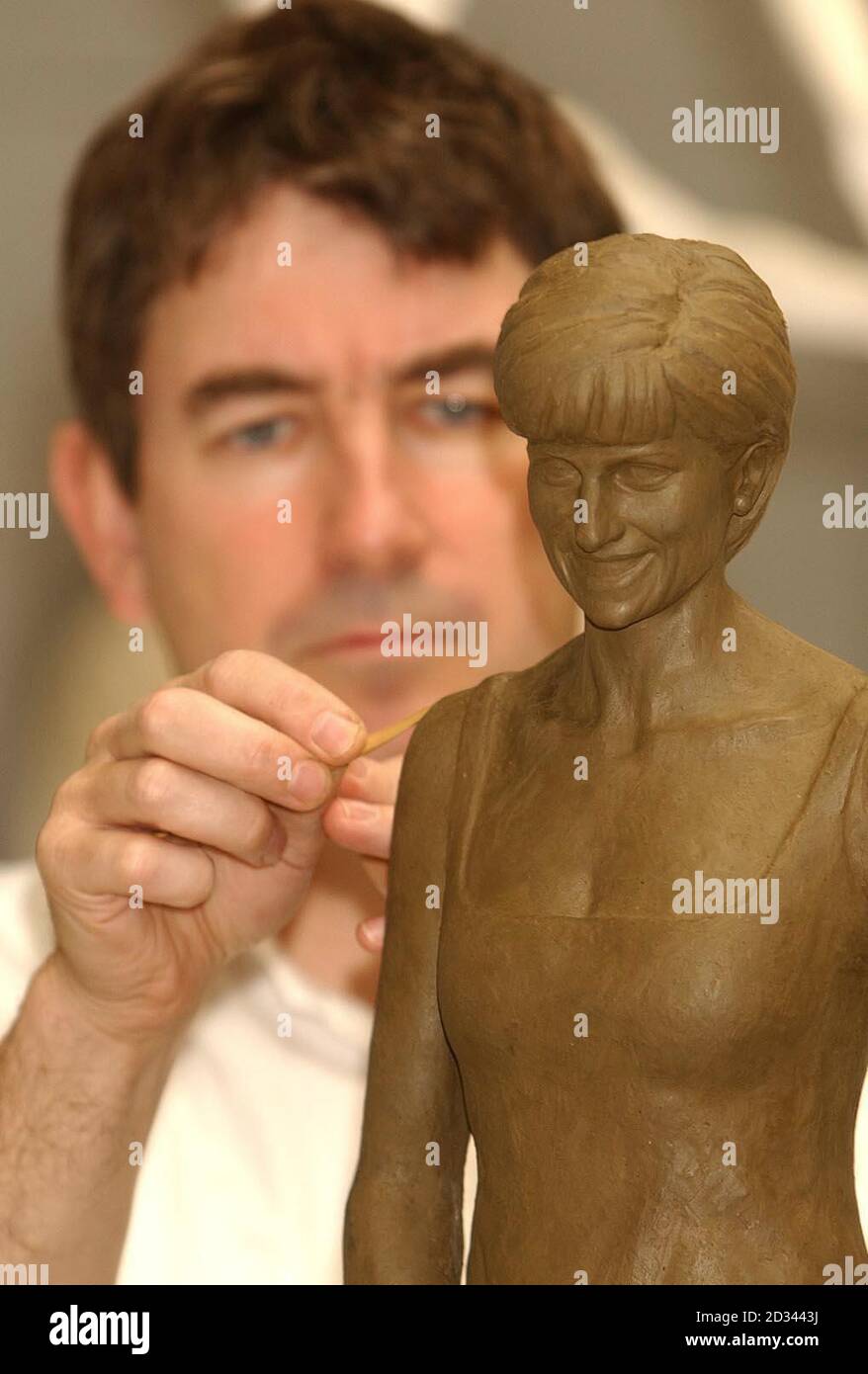 The latest artistic tribute to Diana, Princess of Wales was revealed today - and proved a stark contrast to the beleaguered memorial fountain. The statue shows the princess in a simple floor-length evening gown - devoid of jewellery - and wearing a broad smile Nigel Boonham puts the finishing touches to a 30cm high clay model of the late Princess Diana of Wales, which will become a 3 meter high bronze statue, which will be installed on the South Bank near to the river Thames. Stock Photo