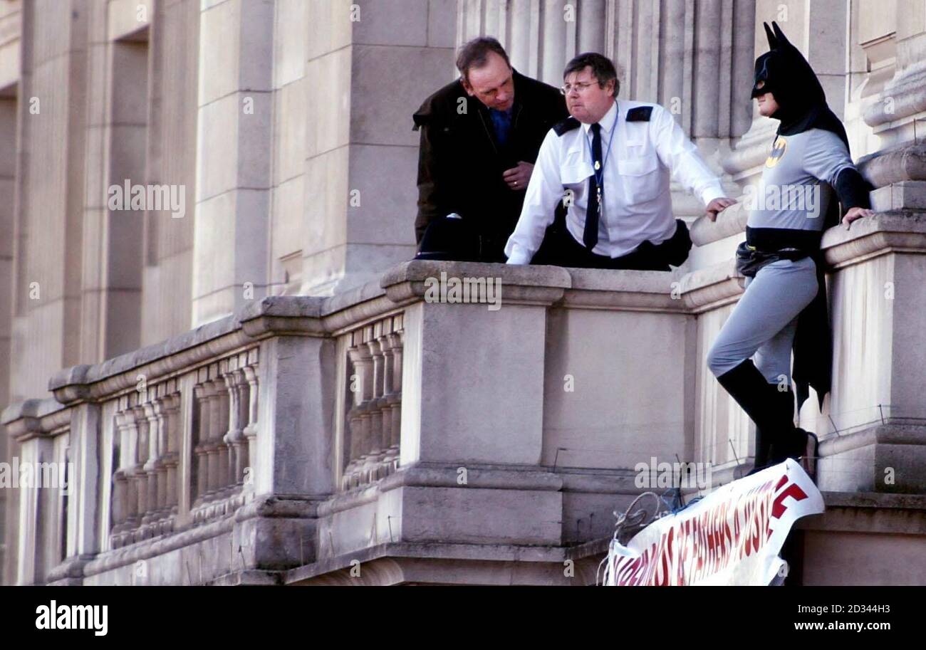 A Fathers 4 Justice campaigner dressed as Batman on a balcony of Buckingham Palace. Jason Hatch, 33, from Gloucester, managed to reach the royal residence despite the presence of armed guards. Security experts and a former Buckingham Palace official today raised concerns about security arrangements at the Royal residence following the protest by Fathers 4 Justice.  Stock Photo