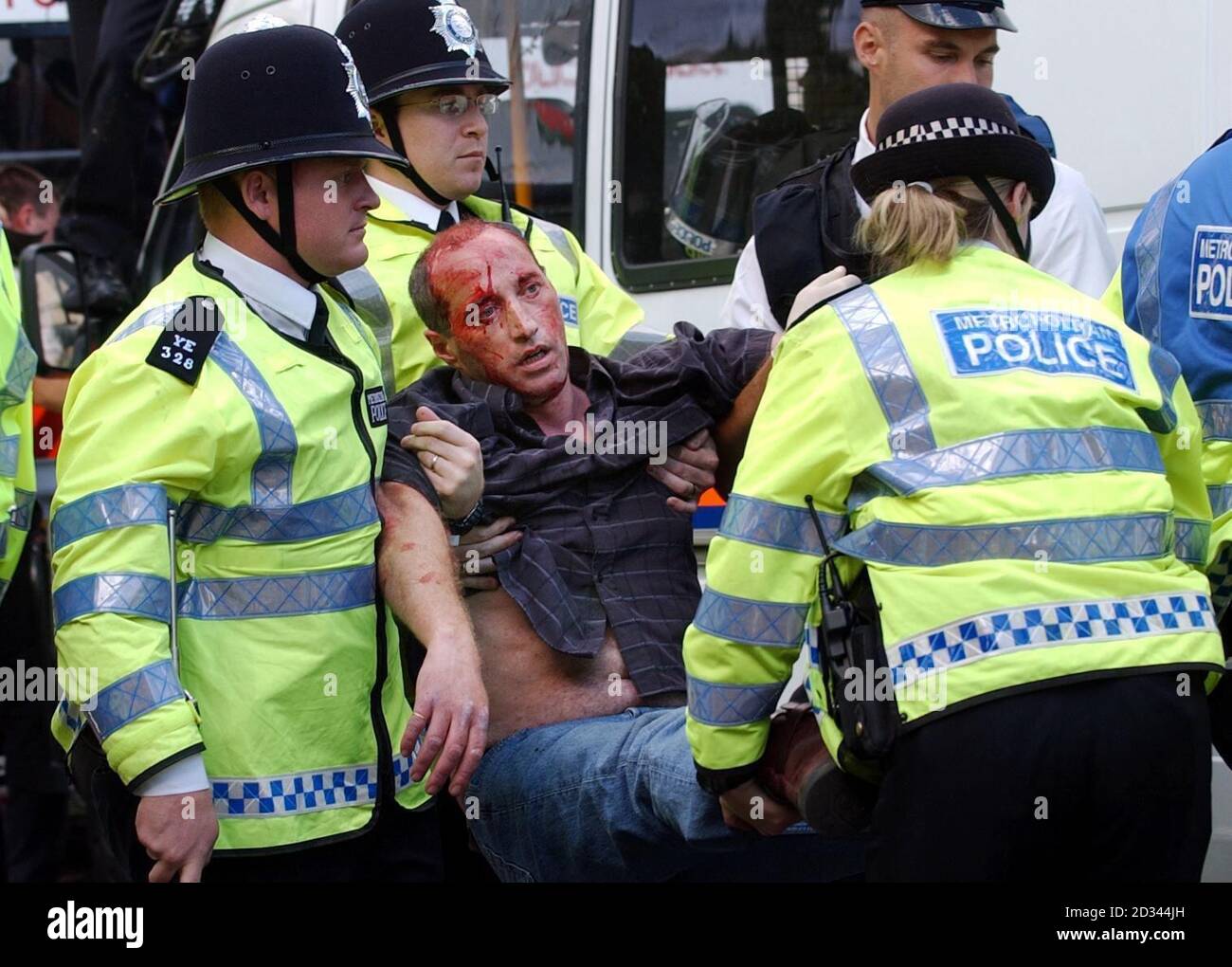 A member of the public is helped by police officers in Parliament Square, central London, during disturbances, ahead of the vote on a controversial Bill which could finally see fox-hunting and hare-coursing banned in England and Wales.  The Hunting Bill will be rushed through the House of Commons in a single day, and the Government has made clear that, if MPs vote for a ban, it will invoke the Parliament Act to quash expected resistance in the Lords. Stock Photo