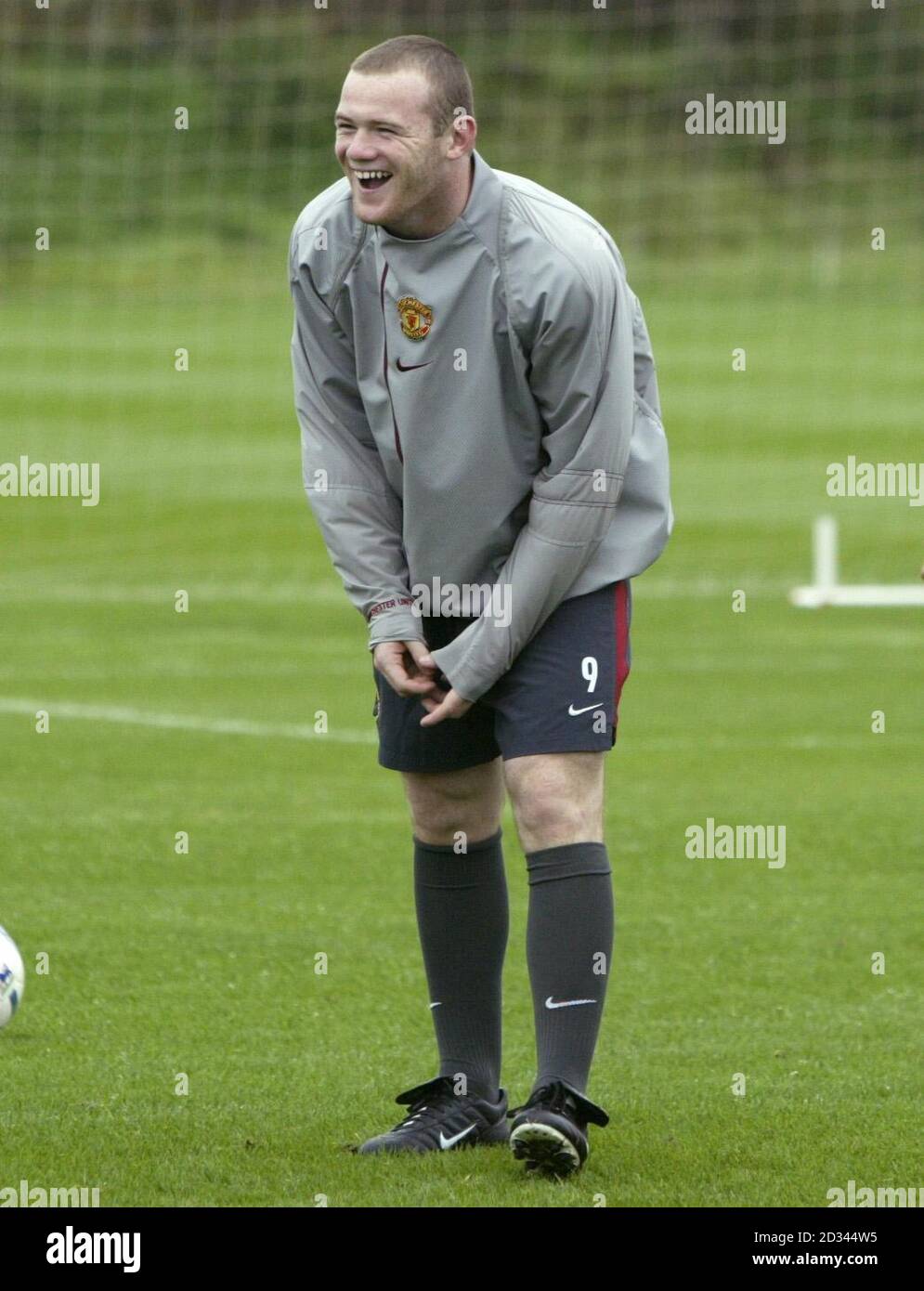 Manchester United's Wayne Rooney laughs during a training session at his  club's Carrington training centre in Manchester ahead of their UEFA  Champions league match against Fenerbahce tomorrow. Rooney is expected to  make