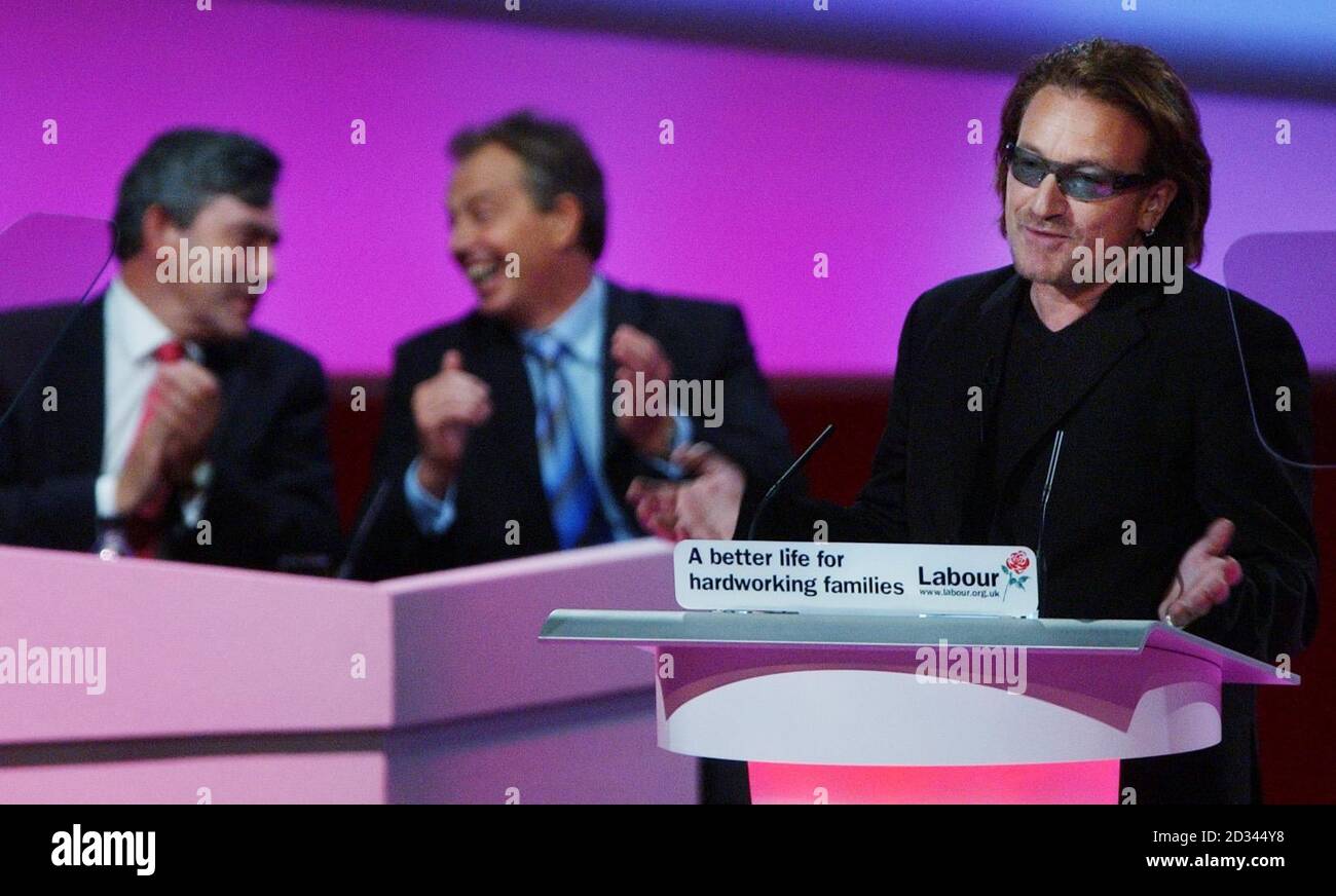 U2 singer and musician Bono speaks to the Labour party conference in Brighton about third world debt relief watched by Prime Minister Tony Blair and Chancellor Gordon Brown. Stock Photo