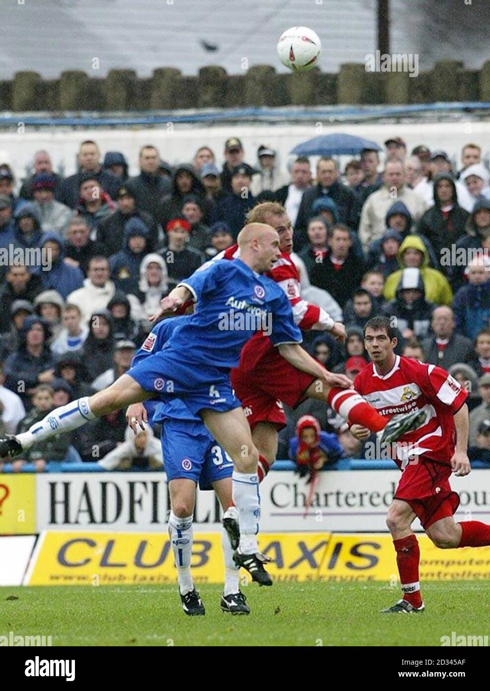 Chesterfield's Derek Niven (front) clears the ball from the Doncaster attack during the Coca-Cola League One match at the Recreation Ground, Chesterfield, Saturday October 23, 2004. This picture can only be used within the context of an editorial feature. NO UNOFFICIAL CLUB WEBSITE USE. Stock Photo