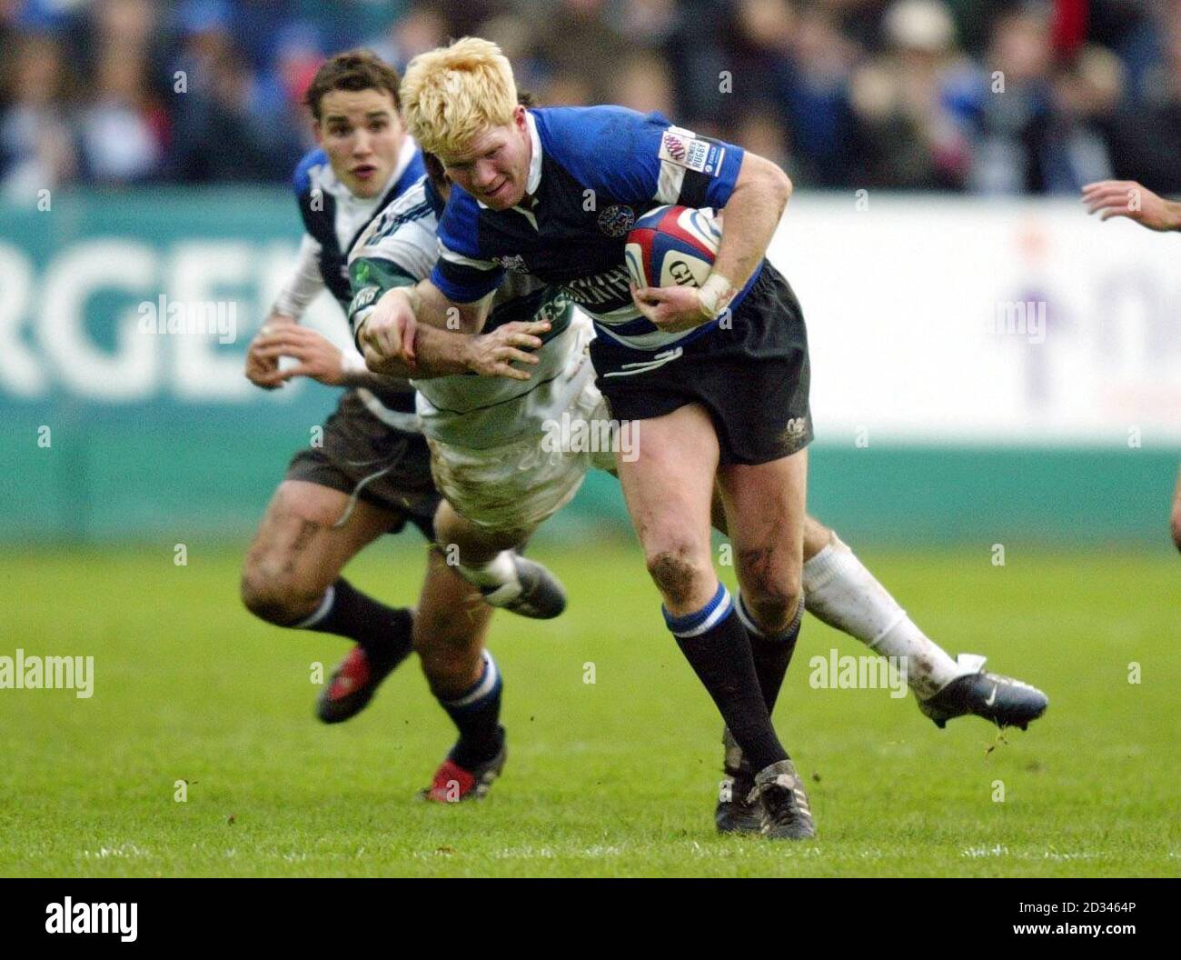 Alex Crockett of Bath (right) hands off the tackle of London Irish player Scott Staniforth during the Zurich Premiership match at the Recreation Ground, Bath. Stock Photo