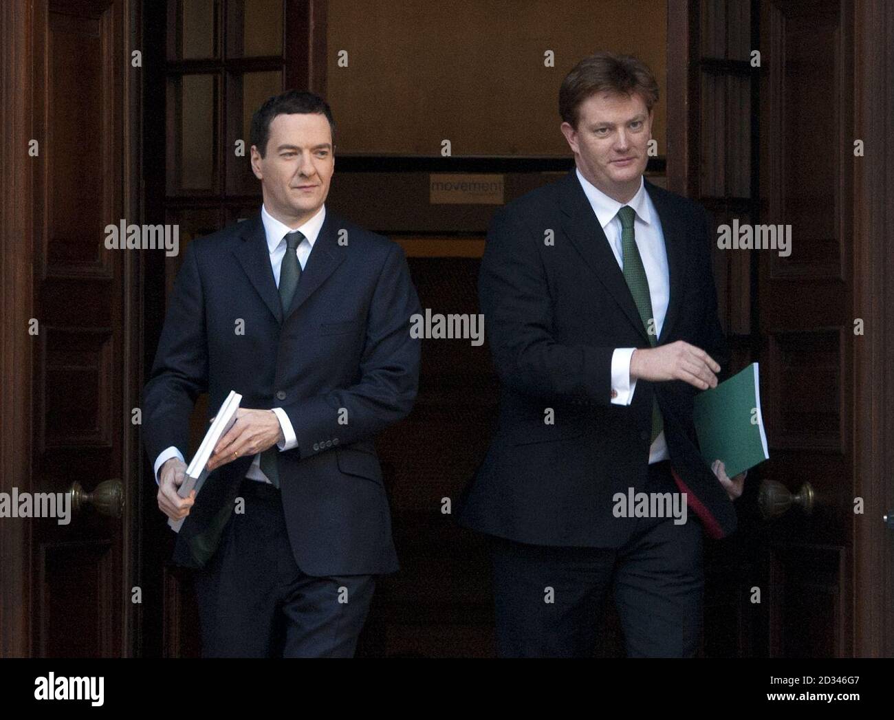 Chancellor of the Exchequer George Osborne (left) and Treasury Chief Secretary Danny Alexander leave the Treasury in London for the House of Commons, where Osborne will deliver his Autumn Statement. Stock Photo