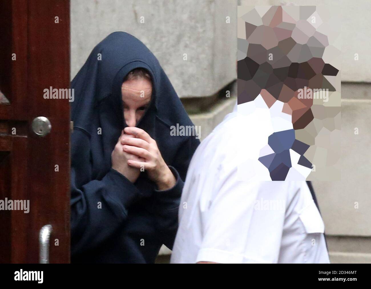 EDS NOTE POLICE OFFICERS FACE AND BADGE NUMBER PIXELATED BY PA PICTURE DESK Lisa Thompson leaves Ballymena Magistrates' Court where she was charged with handling stolen goods following the murder of Chinese restaurant owner Wing Fu &quot;Nelson&quot; Cheung who was killed last week after robbers forced his car off the road in a remote area of Co Antrim.  Stock Photo