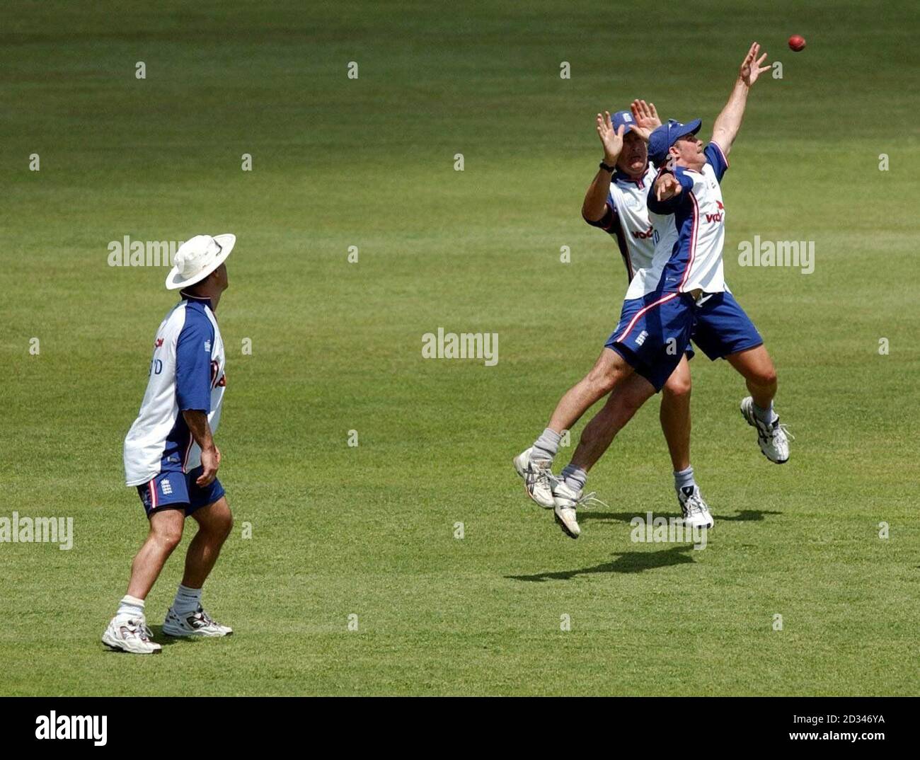 England's Graham Thorpe (left) watches as team-mates Andrew Strauss and Ashley Giles (behind) react for a catch. Stock Photo