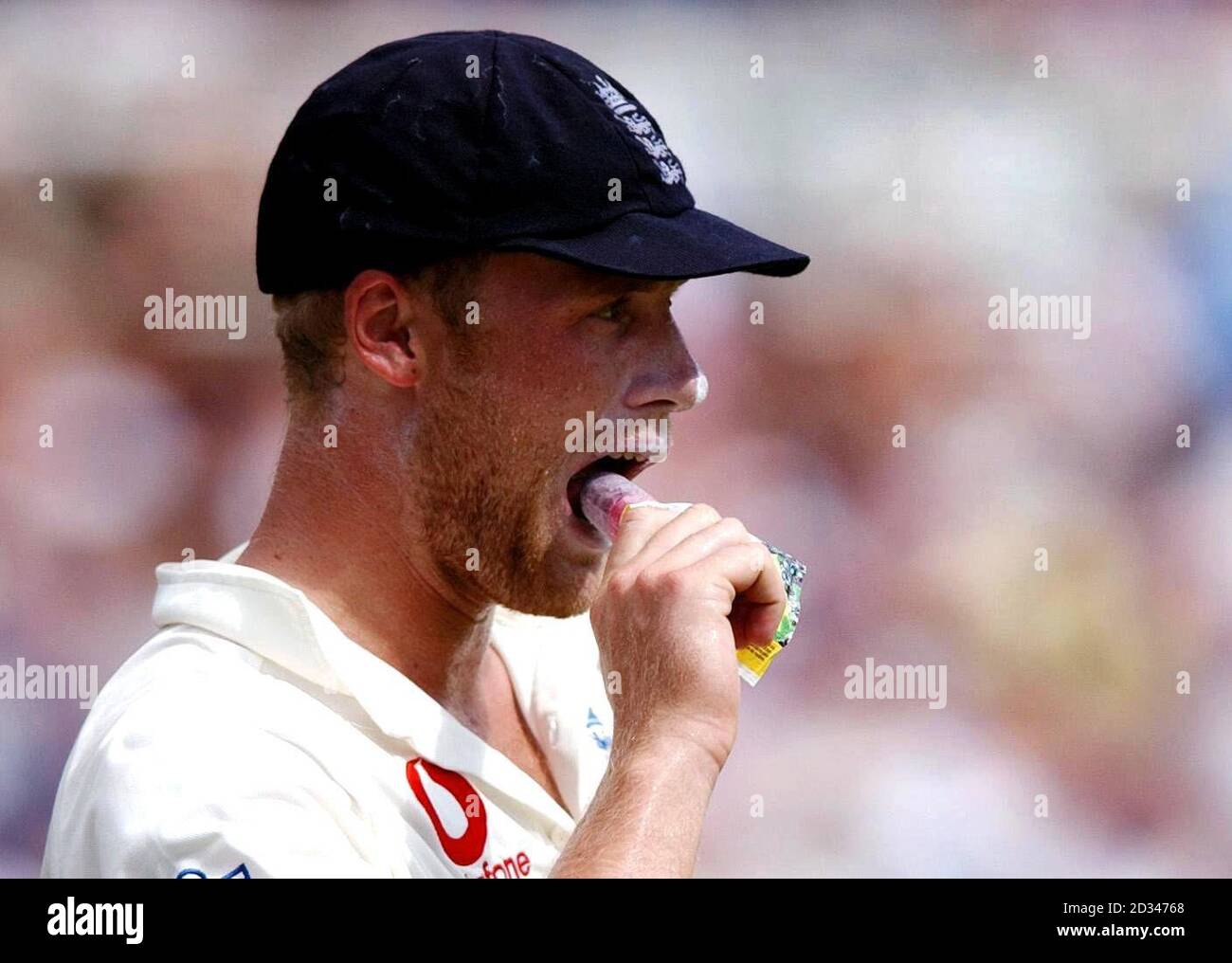 England's Andrew Flintoff bites into an ice-lolly whilst fielding. Stock Photo