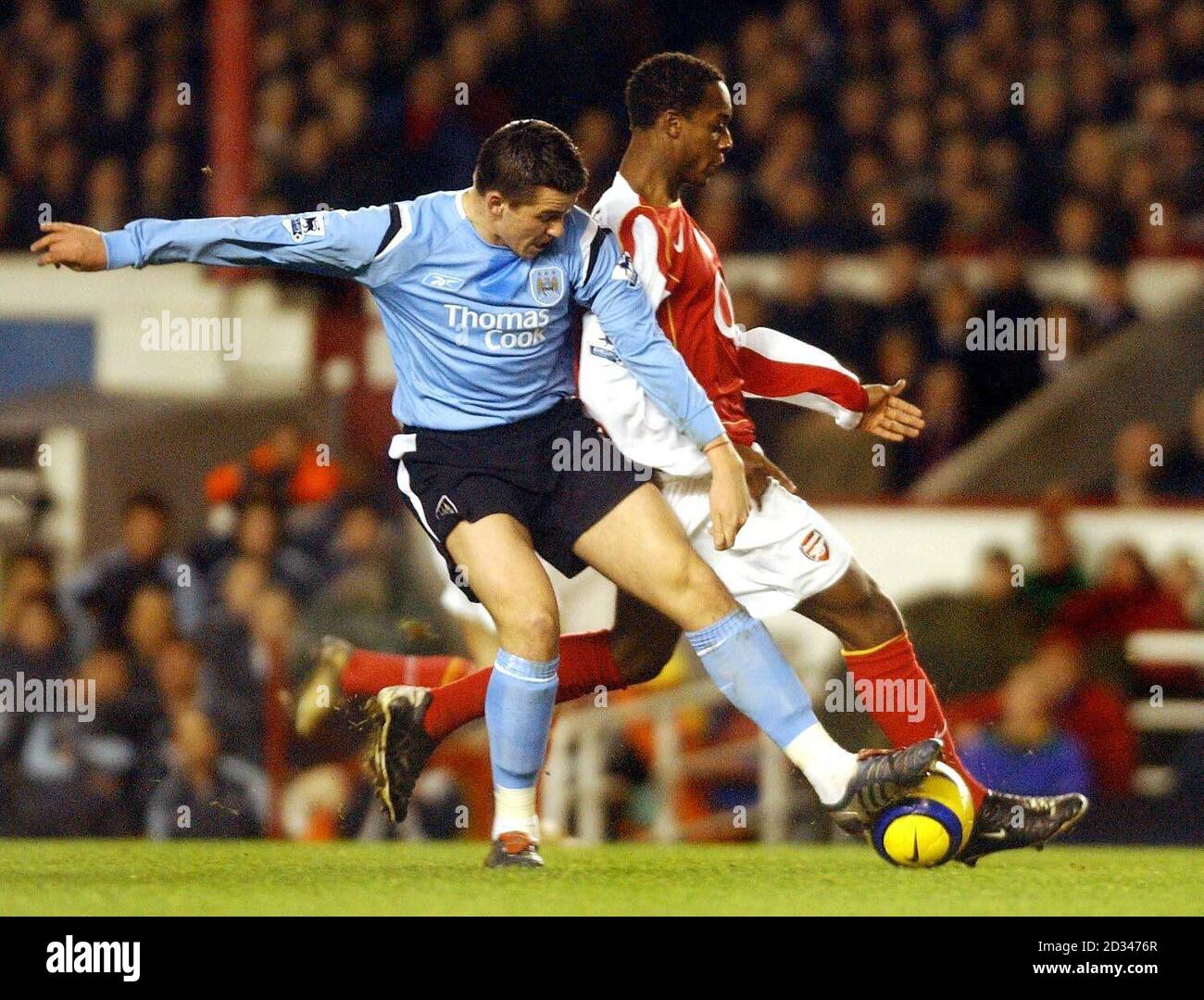Arsenal's Justin Hoyte (right) in action against Joey Barton of Manchester City THIS PICTURE CAN ONLY BE USED WITHIN THE CONTEXT OF AN EDITORIAL FEATURE. NO WEBSITE/INTERNET USE UNLESS SITE IS REGISTERED WITH FOOTBALL ASSOCIATION PREMIER LEAGUE. Stock Photo