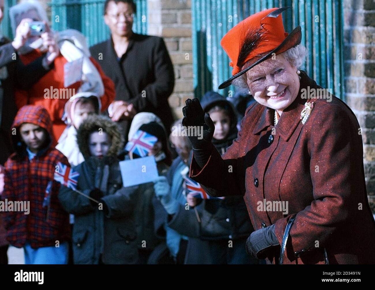 Britain's Queen Elizabeth II waves to members of the 'New Testament Assembly Project', to see Caribbean handicrafts and cooking at the church and community centre. Stock Photo