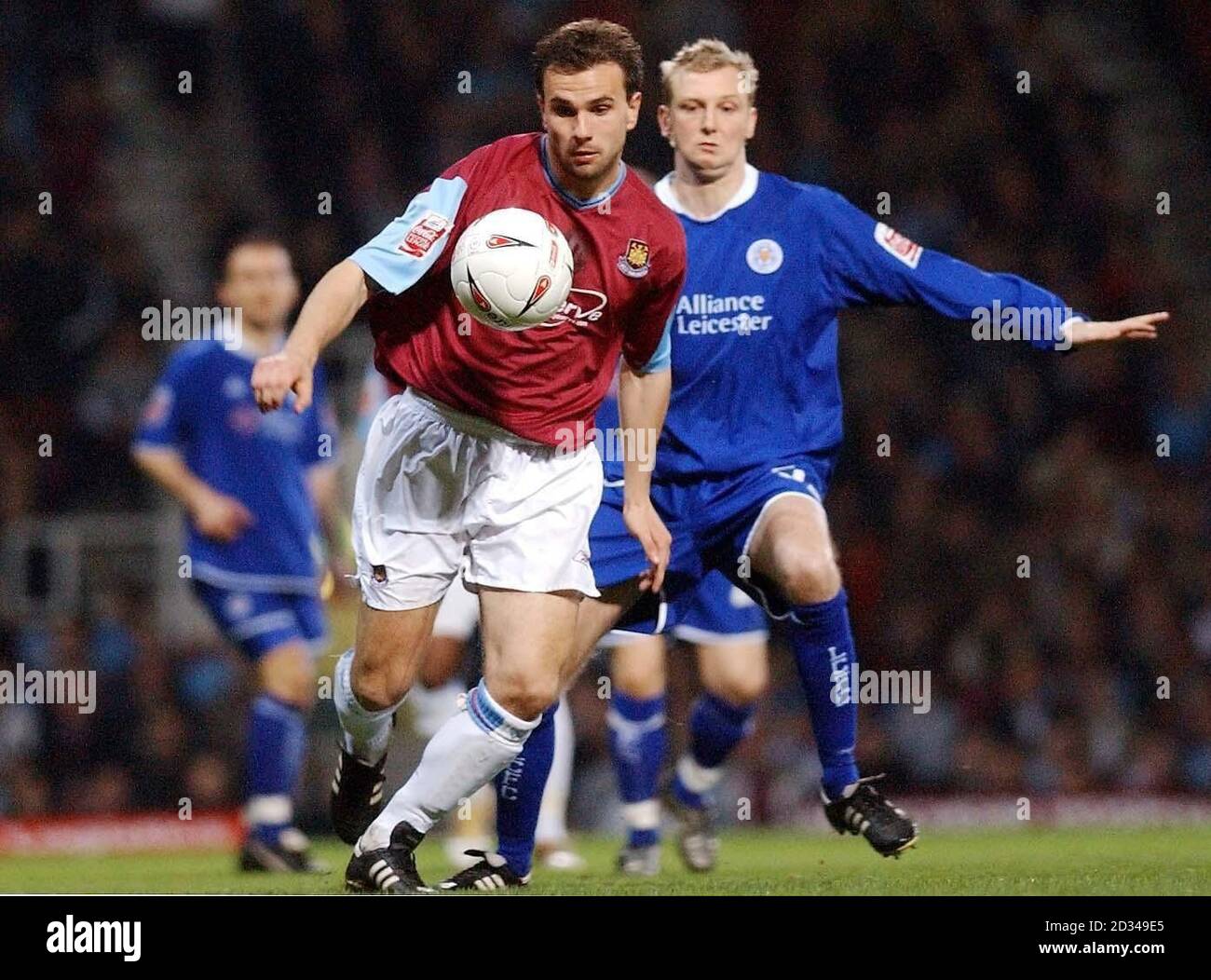 West Ham United's Carl Fletcher (L) goes past Leicester City's Stephen Hughes. Stock Photo