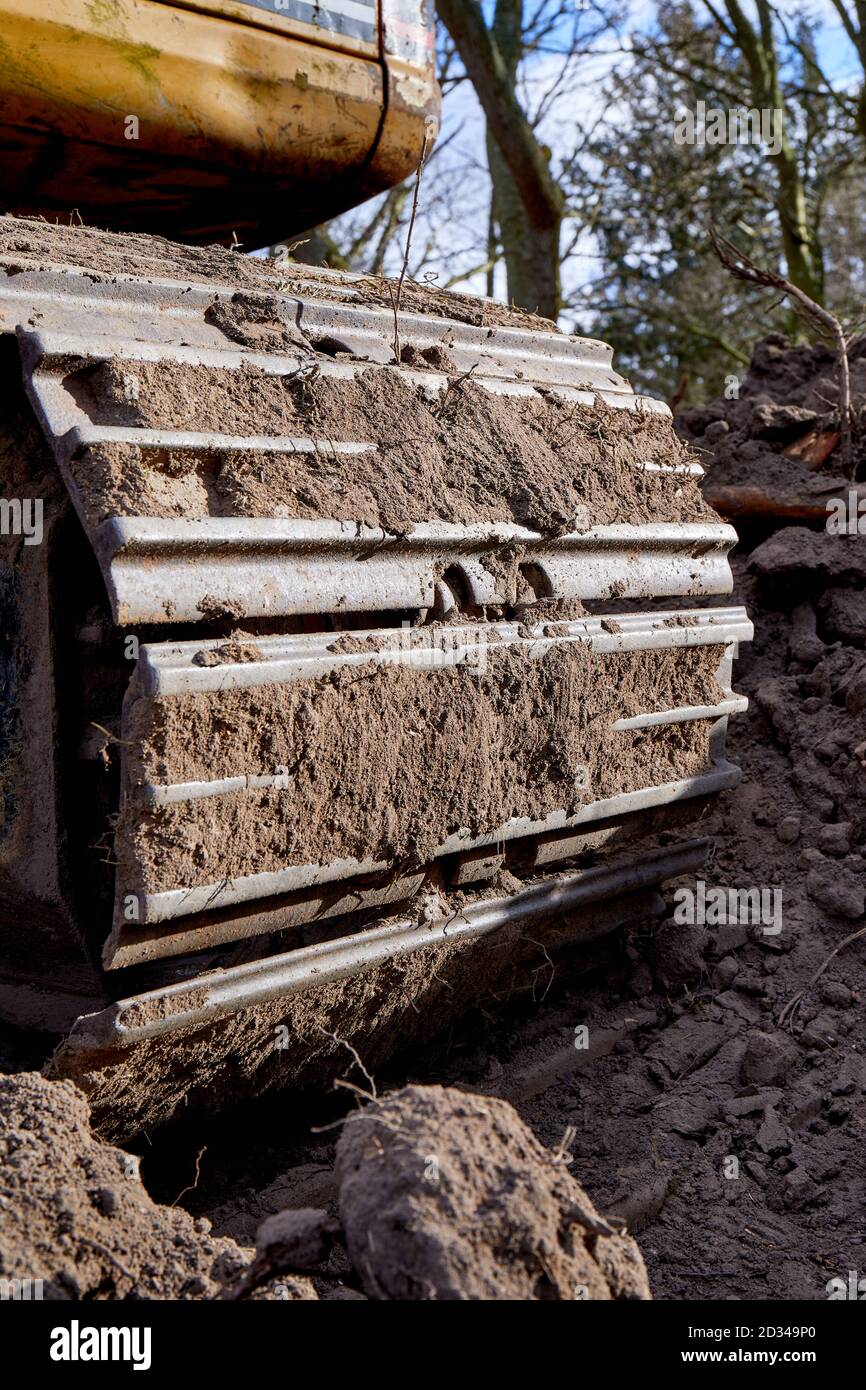 Caterpillar track covered in dirt Stock Photo