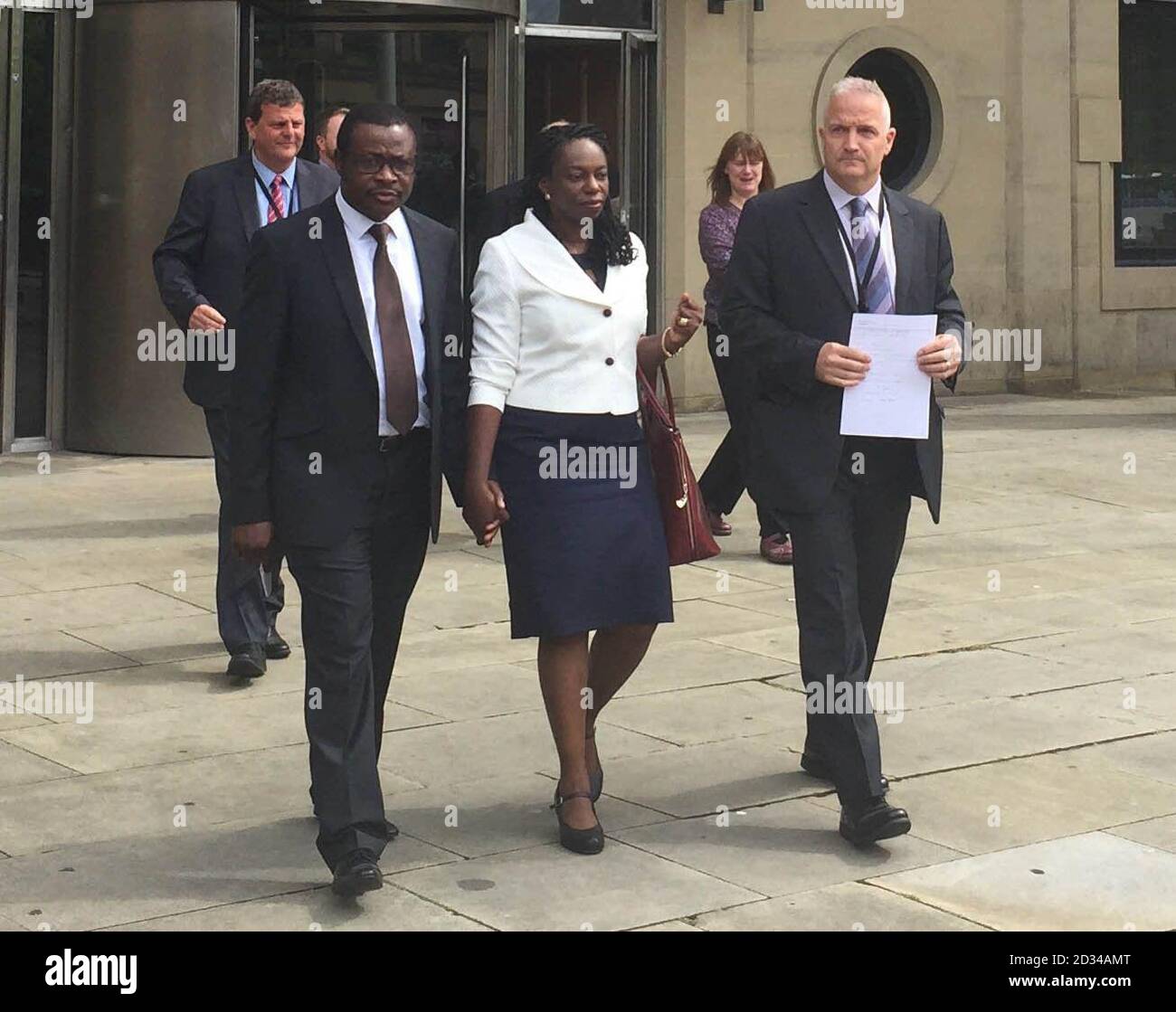 Vincent Uzomah with his wife his wife Uduak and Detective Superintendent Simon Atkinson, of West Yorkshire Police outside Bradford Crown Court after a 14-year-old boy who bragged on Facebook about stabbing the supply teacher in a racially motivated attack has been sentenced to 11 years detention. Stock Photo