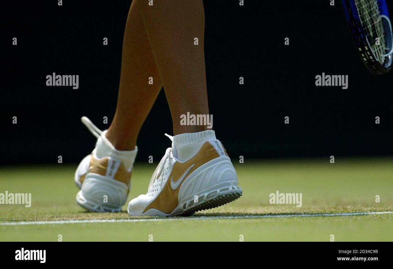 Russia's Maria Sharapova wearing her gold encrusted tennis shoes with her  name 